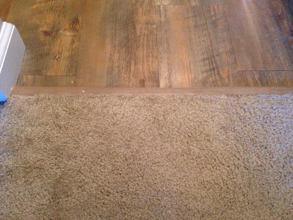 Carpet edge at the floor transition after patch repair, trimmed and secured